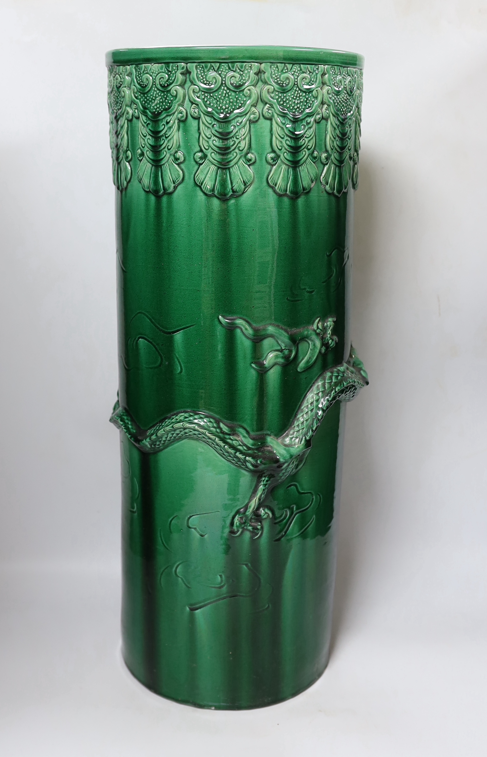 An early 20th century Japanese green glazed ‘dragon’ stick stand, 61cm